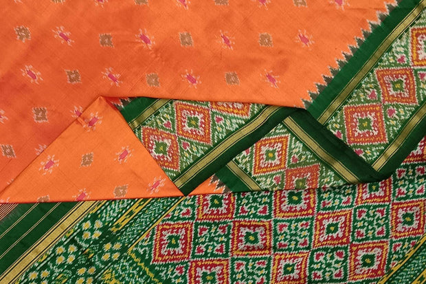 Handwoven ikat pure silk saree in coral orange with small motifs.