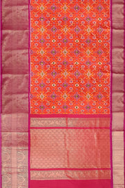 An orange ikat pure silk saree in navratan pattern.