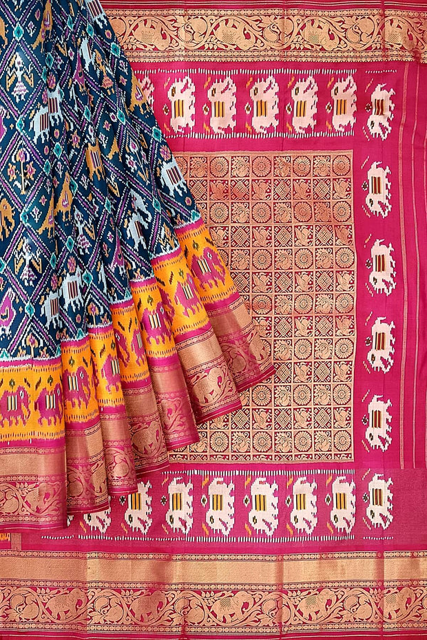 A peacock blue ikat pure silk saree in narikunj pattern with elephant motifs in skirt border.