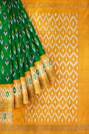 Handwoven ikat pure silk saree in green with anchor motifs on the body