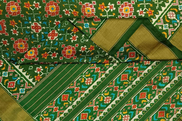 Handwoven ikat pure silk saree in bottle green in navratan pattern