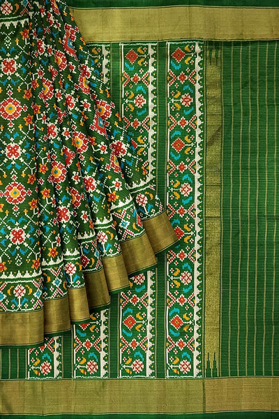 Handwoven ikat pure silk saree in bottle green in navratan pattern