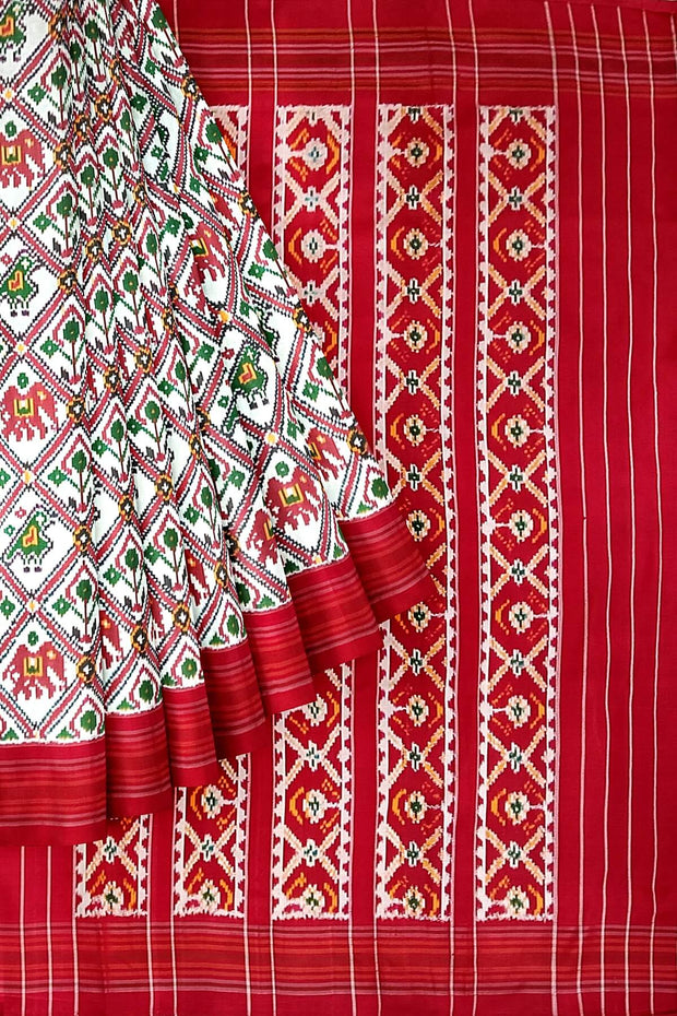 A handwoven twill weave ikat pure silk saree in white  with  narikunj pattern.