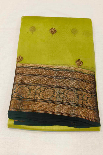 Banarasi kora ( organza) silk saree in gram green with  gold motifs.