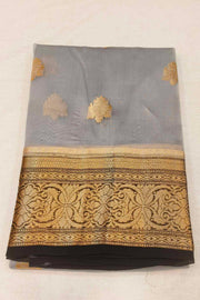 Banarasi kora ( organza) silk saree in grey with  gold motifs.