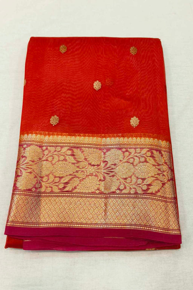 Banarasi kora ( organza) silk saree in red with  gold motifs.