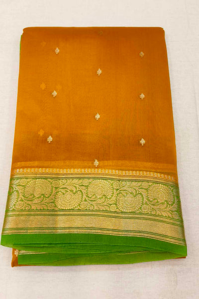 Banarasi kora ( organza) silk saree in mustard with  gold motifs.