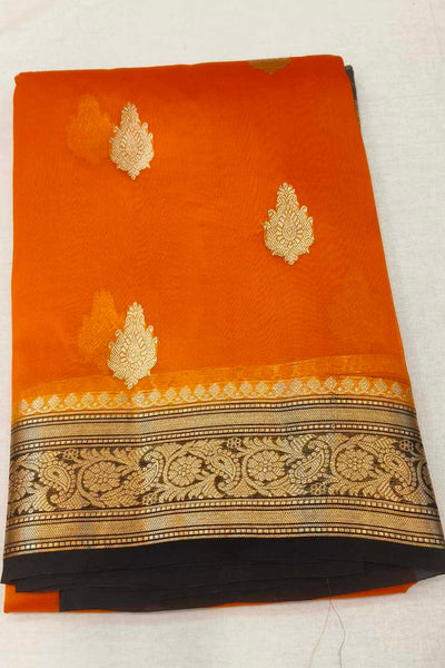 Banarasi kora ( organza) silk saree in orange with  gold motifs.