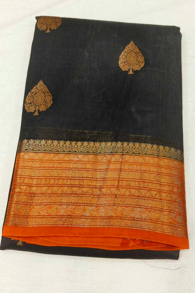 Banarasi kora ( organza) silk saree in black with  gold motifs.