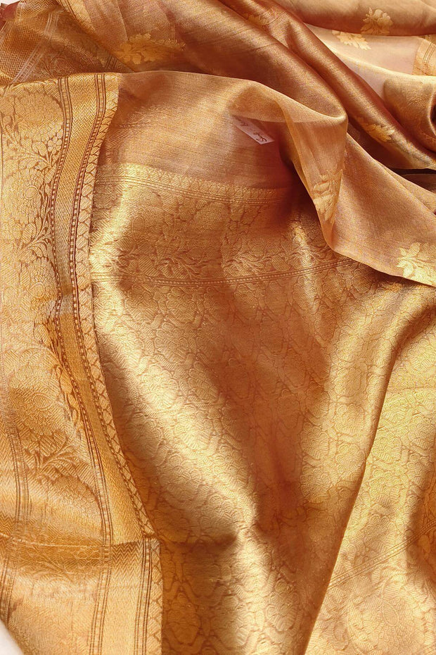 Snuff silk tissue handloom Banarasi saree with floral motifs in gold.