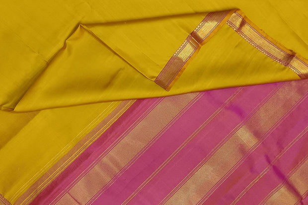 Kanchi pure silk saree in lemon green with a striped contrast pallu