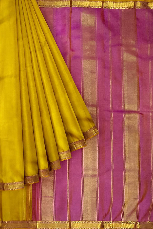 Kanchi pure silk saree in lemon green with a striped contrast pallu