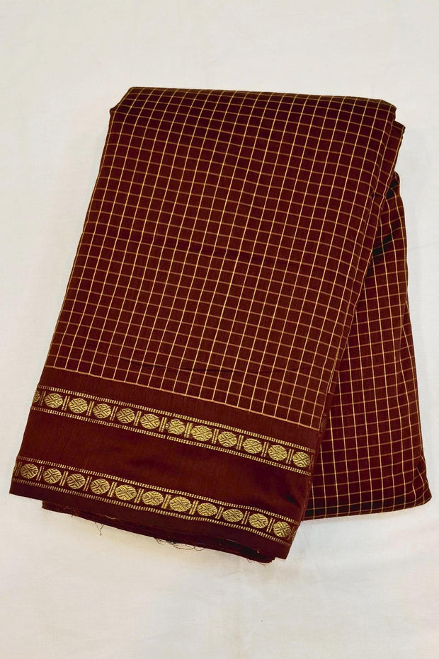 Fine checks silk cotton saree in brown with a contrast pallu in blue.