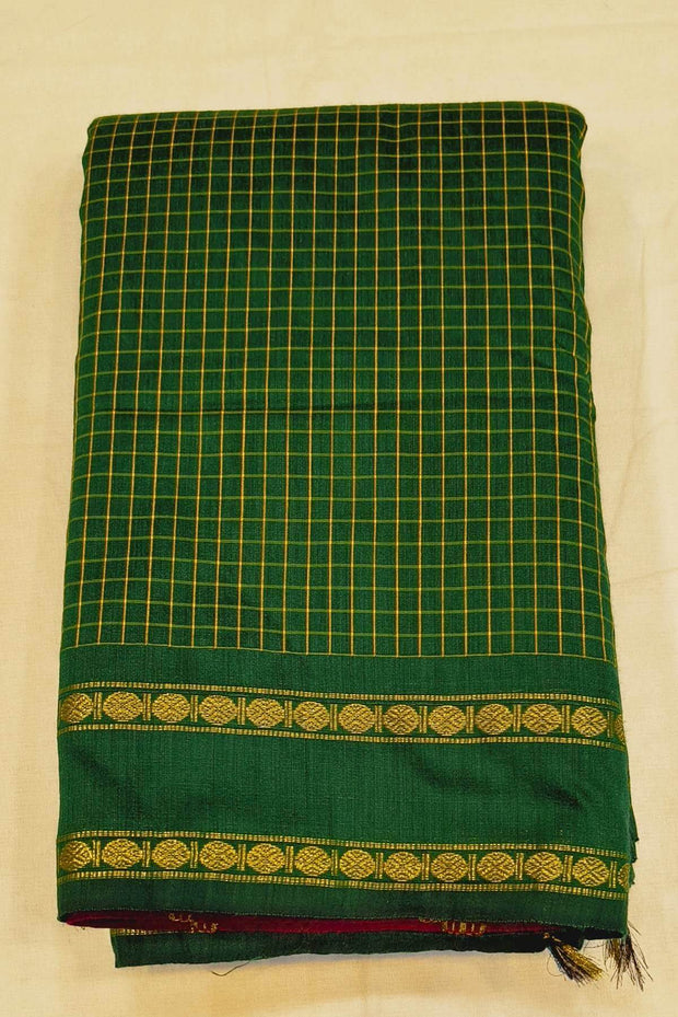 Fine checks cotton saree in green with a contrast pallu in pink.