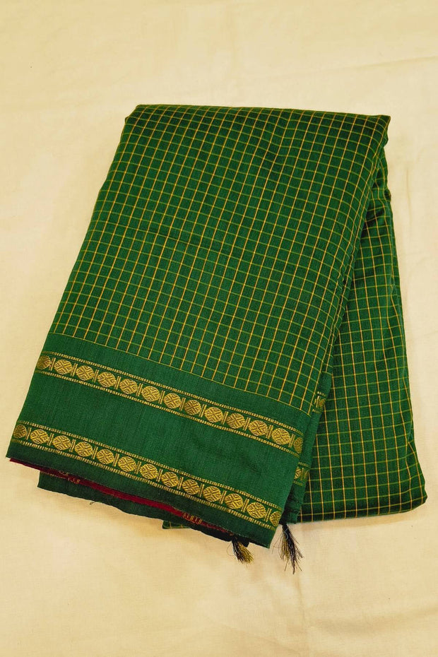 Fine checks cotton saree in green with a contrast pallu in pink.