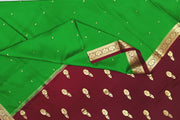 Mysore crepe silk saree in green with small motifs all over the body.