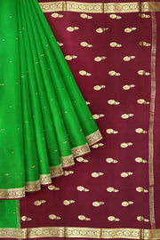 Mysore crepe silk saree in green with small motifs all over the body.