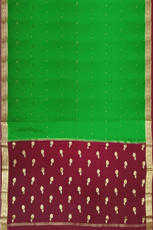 Mysore crepe silk saree in green with small motifs all over the body.