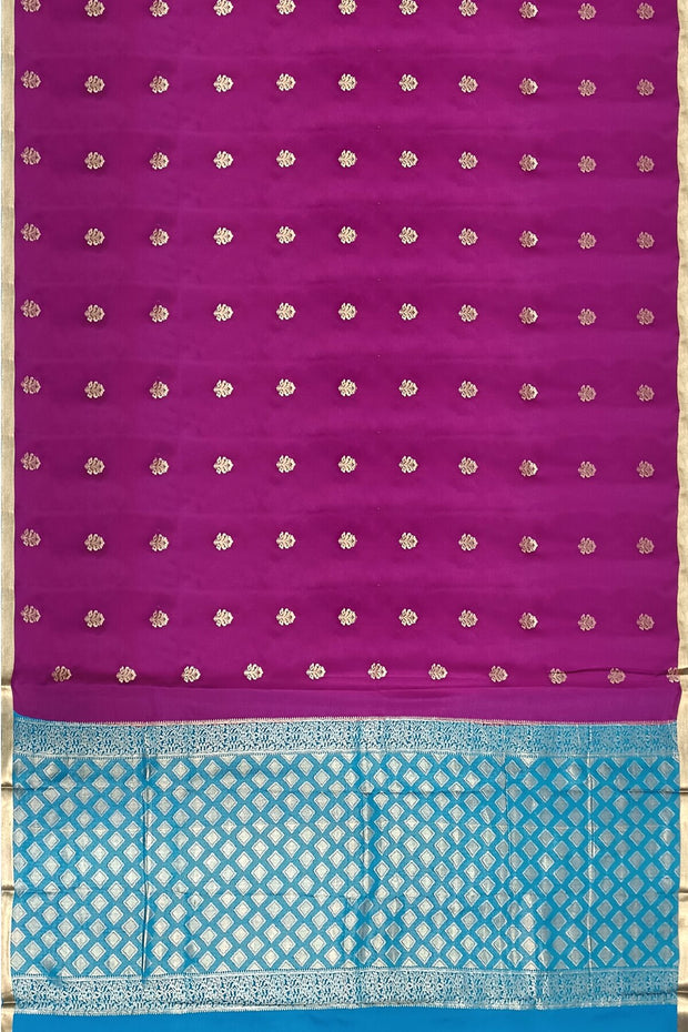 Mysore crepe silk saree in purple with floral  motifs all over the body.