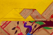 Paithani pure silk saree in yellow  with small motifs and a fancy pallu with muniya border