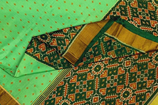 Handwoven Patola pure silk saree in green with small motifs and a skirt border