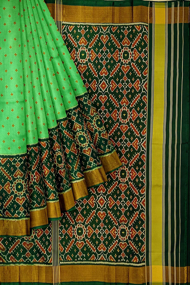 Handwoven Patola pure silk saree in green with small motifs and a skirt border