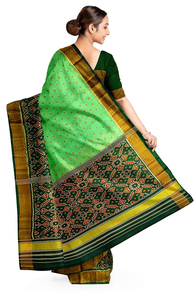 Handwoven Patola pure silk saree in green with small motifs and a skirt border