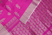 Handwoven Uppada pure silk saree in rani pink with floral motifs.