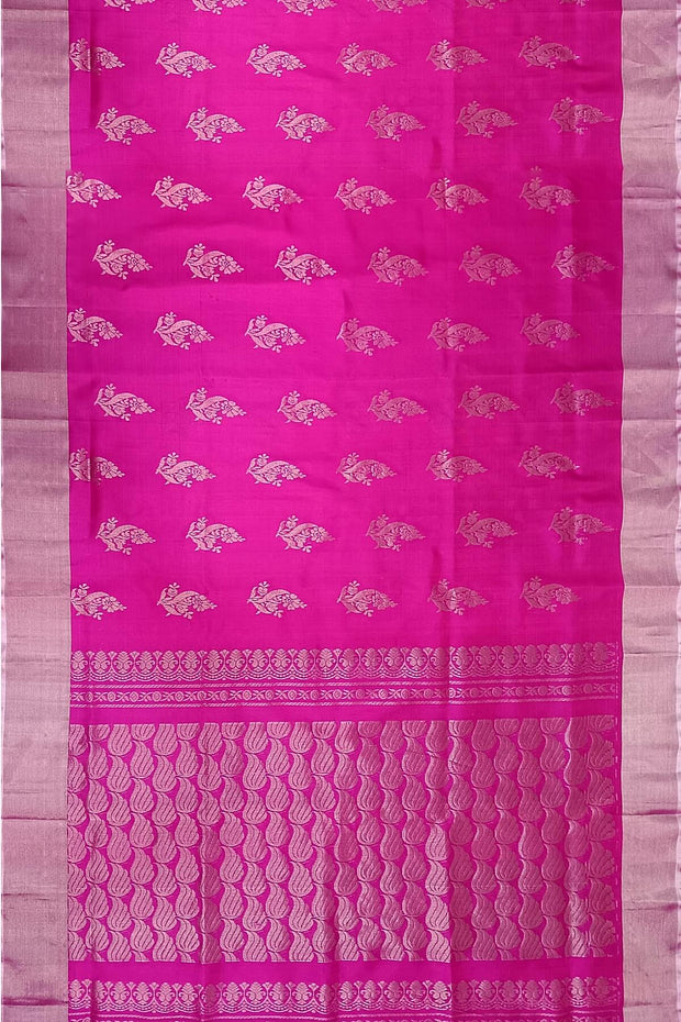 Handwoven Uppada pure silk saree in rani pink with floral motifs.