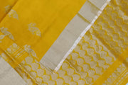 Handwoven Uppada pure silk saree in yellow with floral motifs .