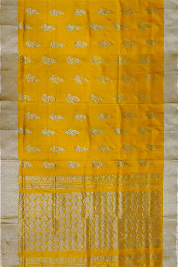 Handwoven Uppada pure silk saree in yellow with floral motifs .