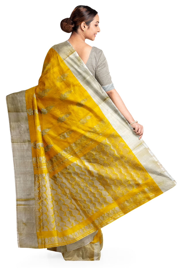 Handwoven Uppada pure silk saree in yellow with floral motifs .