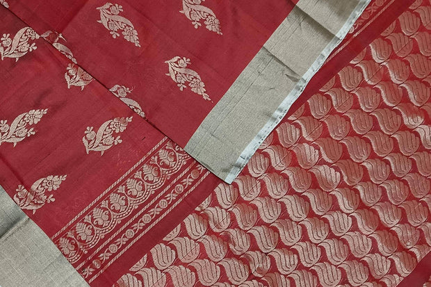 Handwoven Uppada pure silk saree in maroon with floral motifs.