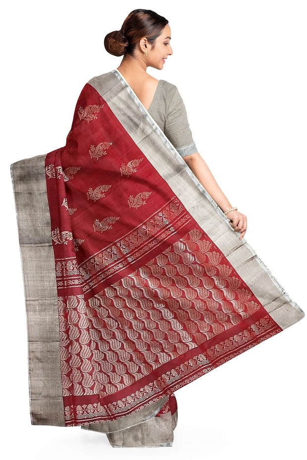 Handwoven Uppada pure silk saree in maroon with floral motifs.