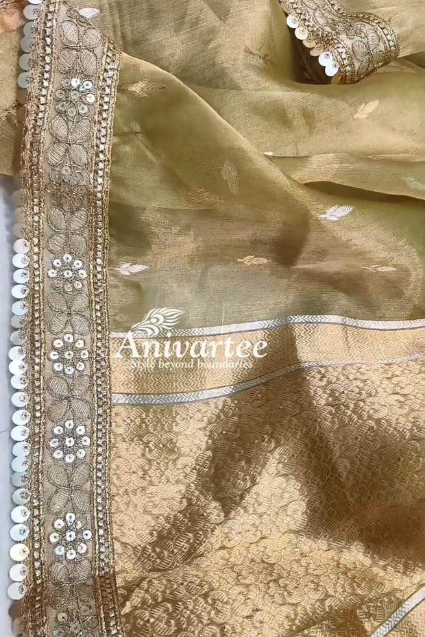 Green silk tissue handloom Banarasi saree with floral motifs and a lace border.